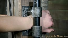 Restrained redhead sitting on a sybian and getting her throat fucked