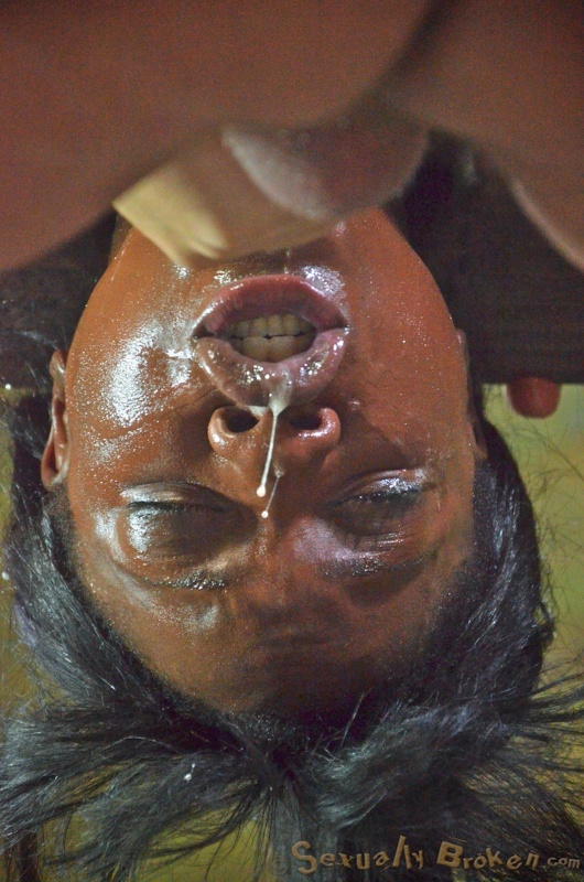 Suspended athletic ebony with a white dick in the mouth