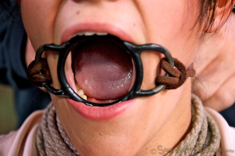 Two older men abuse the throat of a busty bound teen